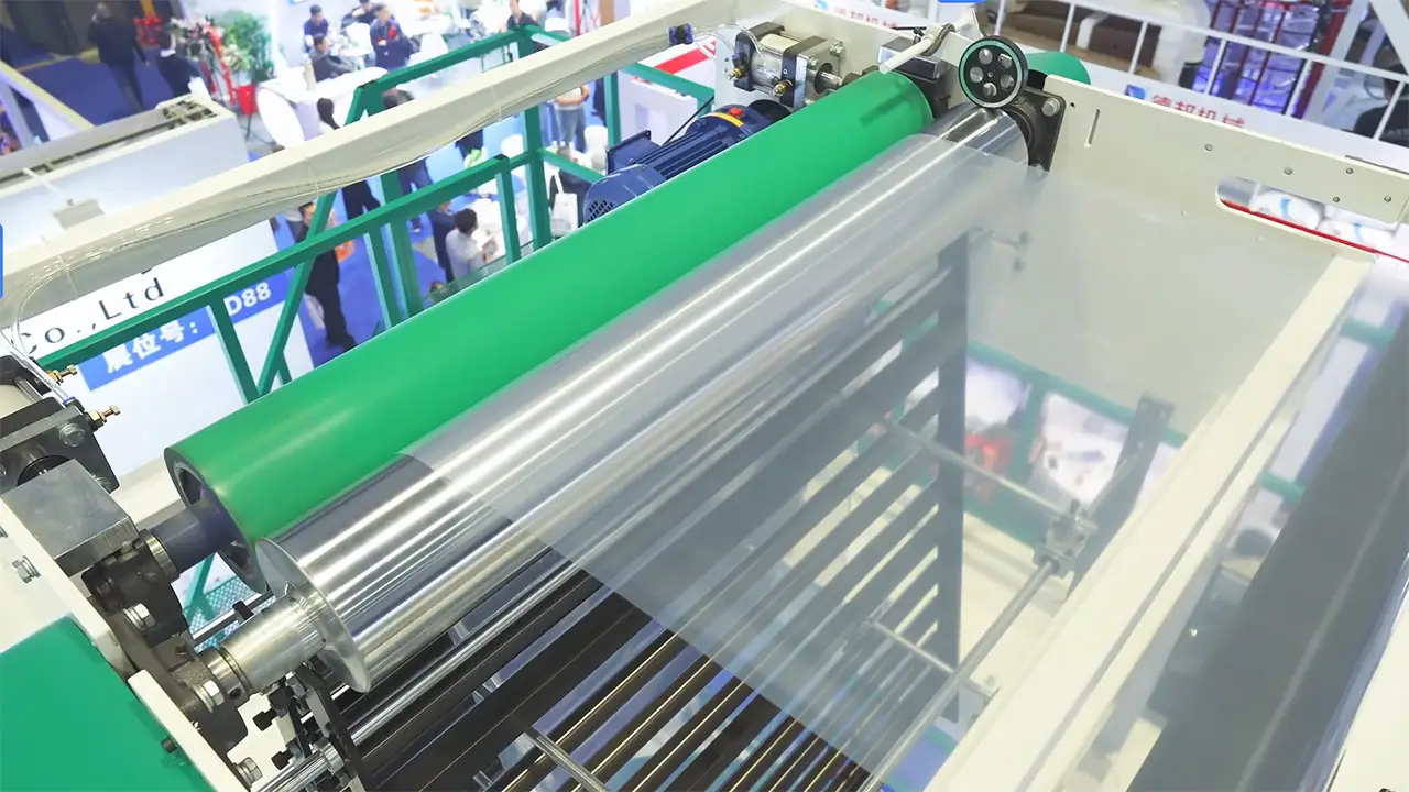 High-precision traction and winding system of a Yuexing multi-layer blown film machine, showing crystal-clear film produced under tension
